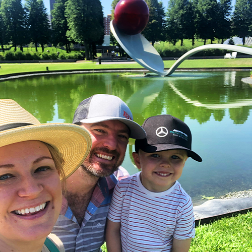 mom, dad and son in front of cherry and the spoon sculpture