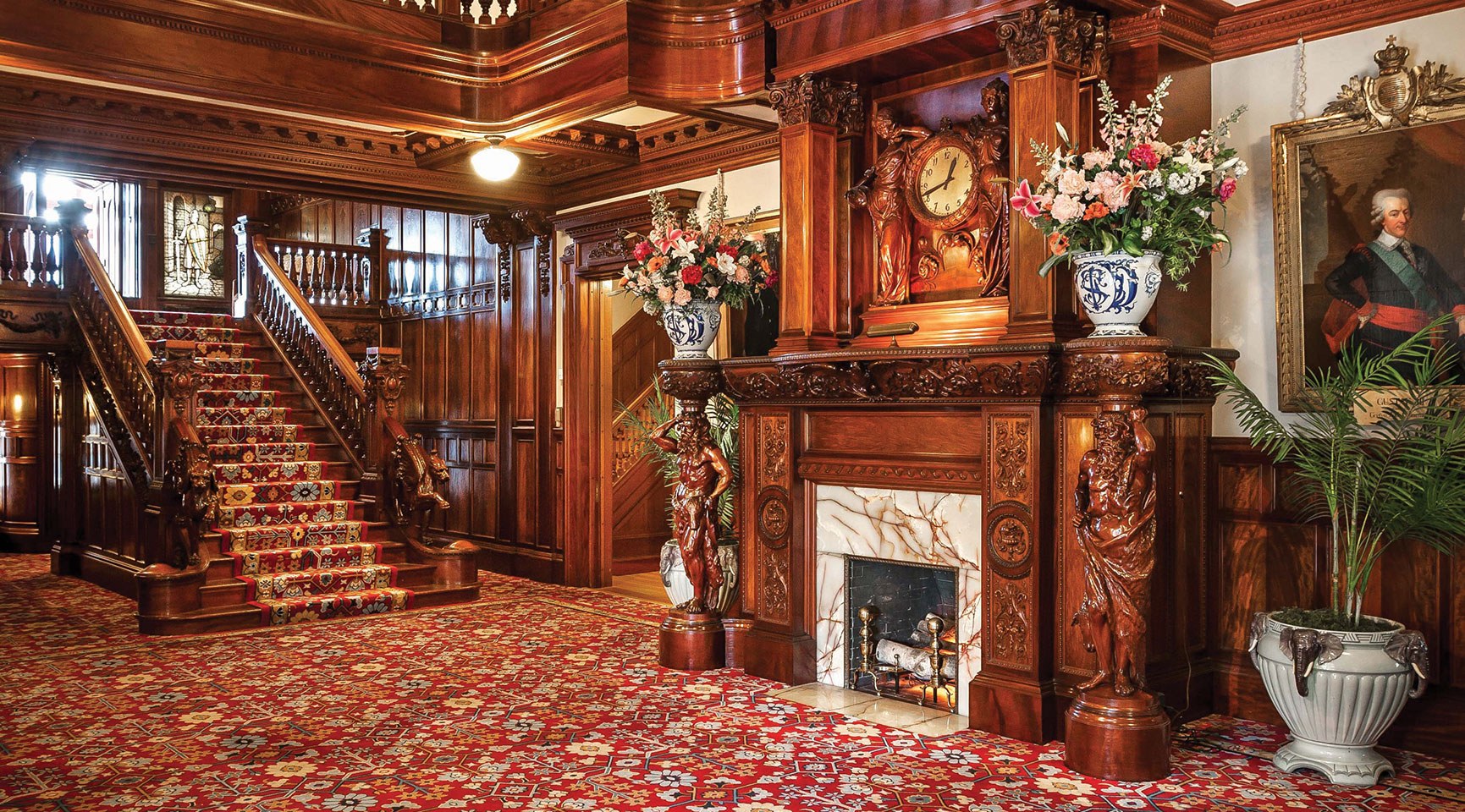 foyer of the mansion with the fireplace and staircase