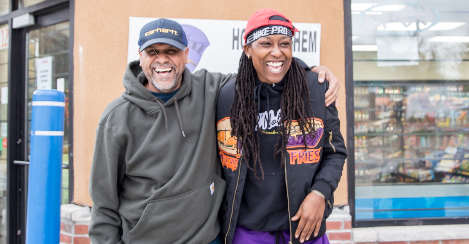 owners of qnoble and E&L smiling outside of storefront