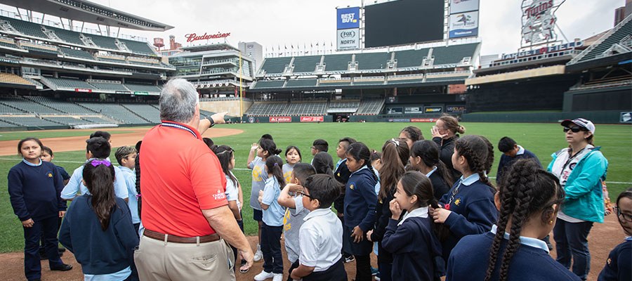 group of students listening to a tour at target field